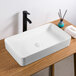 A white rectangular Ruvati Vista above-counter sink on a wood surface.