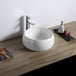 A white Ruvati Vista vessel sink on a wooden surface.