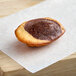 A St. Michel Chocolate Marble Madeleine on a paper.