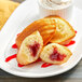A white plate with St. Michel strawberry-filled madeleines.