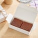 A Nats Rawline plant-based vegan tiramisu raw cake square in a white box.