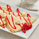 A Le Chic Patissier Classic crepe with whipped cream and a strawberry.