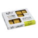 A box of Nats Rawline plant-based vegan lime and mango raw cake squares on a yellow surface.