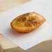 A St. Michel Creme Brulee Madeleine on a piece of white paper.