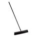 A Lavex push broom with a black handle.