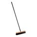 A close up of a Lavex wood push broom with a long handle.