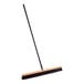 A Lavex wood push broom with a long metal handle.