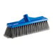 A blue broom head with gray bristles.