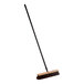 A close-up of a Lavex wood push broom with a long metal handle.