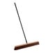 A Lavex wood push broom with a long metal handle.