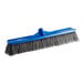A close-up of a Lavex blue indoor/outdoor push broom head with gray flagged bristles.