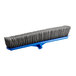 A close-up of a blue and grey Lavex push broom head with gray flagged bristles.