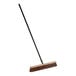 A Lavex brown wood push broom with a long metal handle.