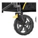 The yellow front wheel of a Gorilla Collapsible Utility Wagon.