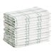 A stack of white and green striped waffle-weave dish cloths.