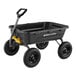 A black poly yard dump cart with yellow handles and wheels.