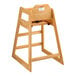 A Lancaster Table & Seating wooden high chair with a seat belt.