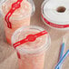 Two plastic cups of frozen drinks with TamperSafe red paper flat lids.