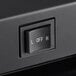 A close up of a black plunger switch on a black box.