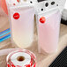 A plastic bag with a roll of Point Plus red alcohol labels with red dots on it.