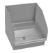 A grey rectangular metal mop sink with a metal grate on top.