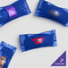 A blue package of customizable chocolate pastel mints with navy wrapper and yellow text.