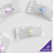 A clear plastic bag filled with individually wrapped white chocolate pastel mints with white customized wrappers.