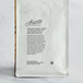 A white bag of Arrosto Mexican Altura Mountain Water Decaf Whole Bean Coffee with text and leaves on it.