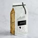 A case of 5 bags of Arrosto Kenya AA whole bean coffee with a label.