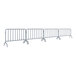A row of AdirPro interlocking metal barricades with legs.