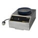 A Dinex DuraTherm induction charger with a black round object on top.