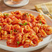 A plate of pasta with RedPack tomato puree and a fork.