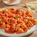 A plate of pasta with RedPack tomato sauce and a fork.