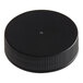 A black plastic cap with ribbing and a small dot.