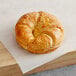 A Pillsbury croissant on a cutting board.