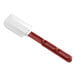 A close-up of a white and red Vollrath high heat silicone spatula.