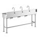 A stainless steel Regency hand sink with three knee-operated faucets.
