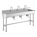 A stainless steel Regency hand sink with three knee-operated faucets.
