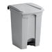 A grey rectangular step-on trash can with a lid.