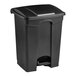 A Lavex black rectangular step-on trash can with a lid.