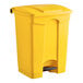 A close-up of a yellow Lavex step-on trash can with a black pedal.