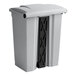 A gray Lavex step-on trash can with a black handle.