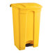 A yellow plastic Lavex step-on trash can with a black lid.