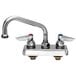 A silver T&S deck-mounted workboard faucet with two handles and a 12" swing nozzle.
