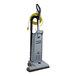 An Advance Spectrum 18D upright vacuum cleaner with a yellow cord and grey handle.