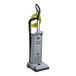 A grey vacuum cleaner with yellow tubes.