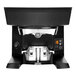 A black PUQpress M2 automatic espresso tamper on a counter.