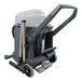 An Advance VL500 wet/dry vacuum with a hose attached, wheels, and a handle.