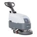 An Advance SC370 walk behind floor scrubber machine with wheels and a handle.