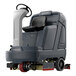 An Advance SC5000 ride-on cylindrical floor scrubber with a seat and wheels.